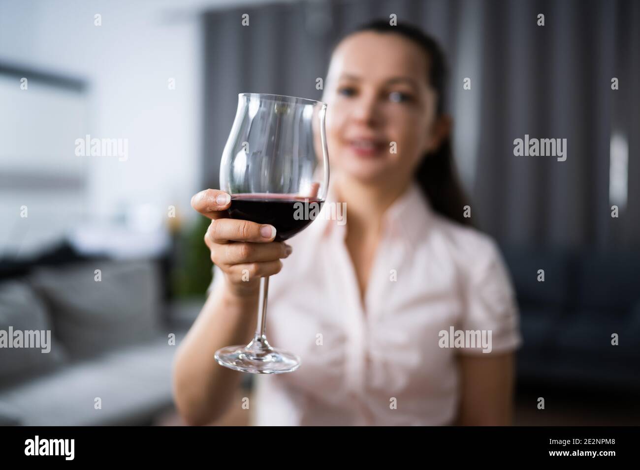 Woman Drinking Red Wine In Video Conference At Home Stock Photo - Alamy