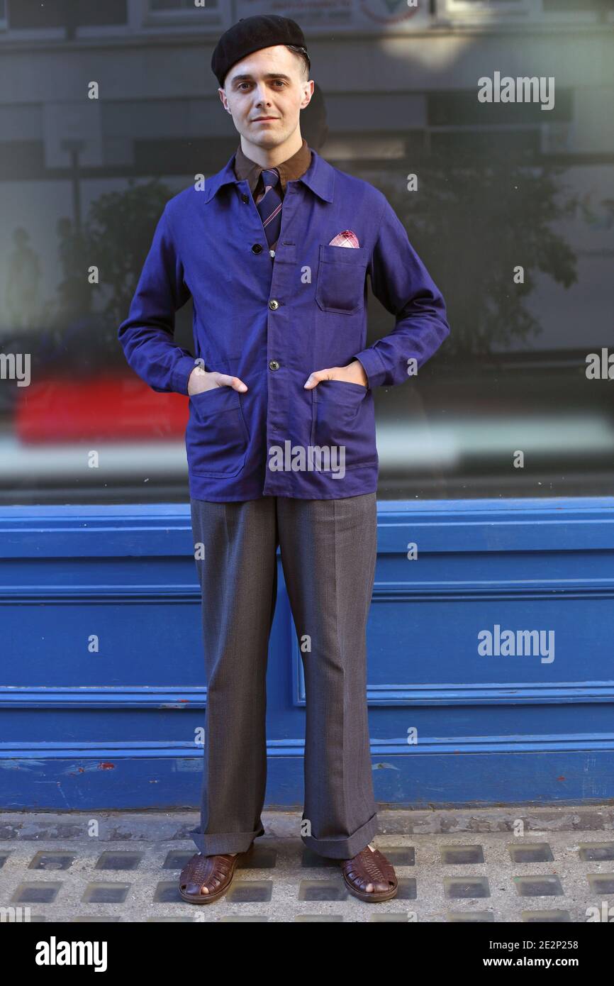 Young man with  french worker’s jacket and baret standing outside shop store front in Soho, London. Stock Photo