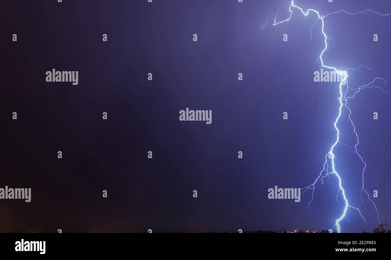 Mighty lightning strike in the purple shaded sky Stock Photo - Alamy