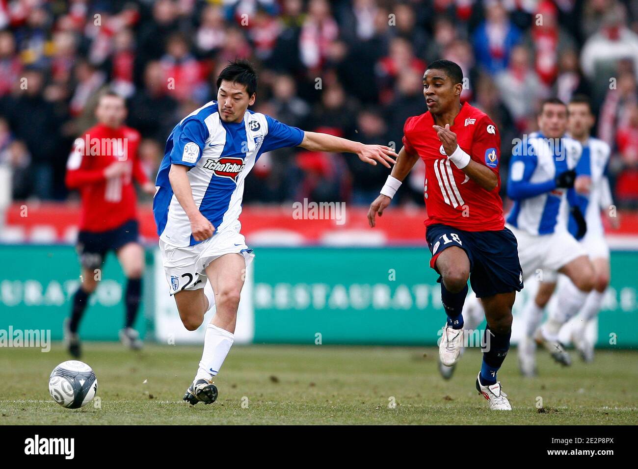Lille's Franck Beria fights for the ball with Grenoble's Matsui during the French First League soccer match, Lille OSC vs Grenoble F38 at Lille Metropole Stadium in Lille, France on March 14, 2010. Lille won 1-0. Photo by Mikael LIbert/ABACAPRESS.COM Stock Photo
