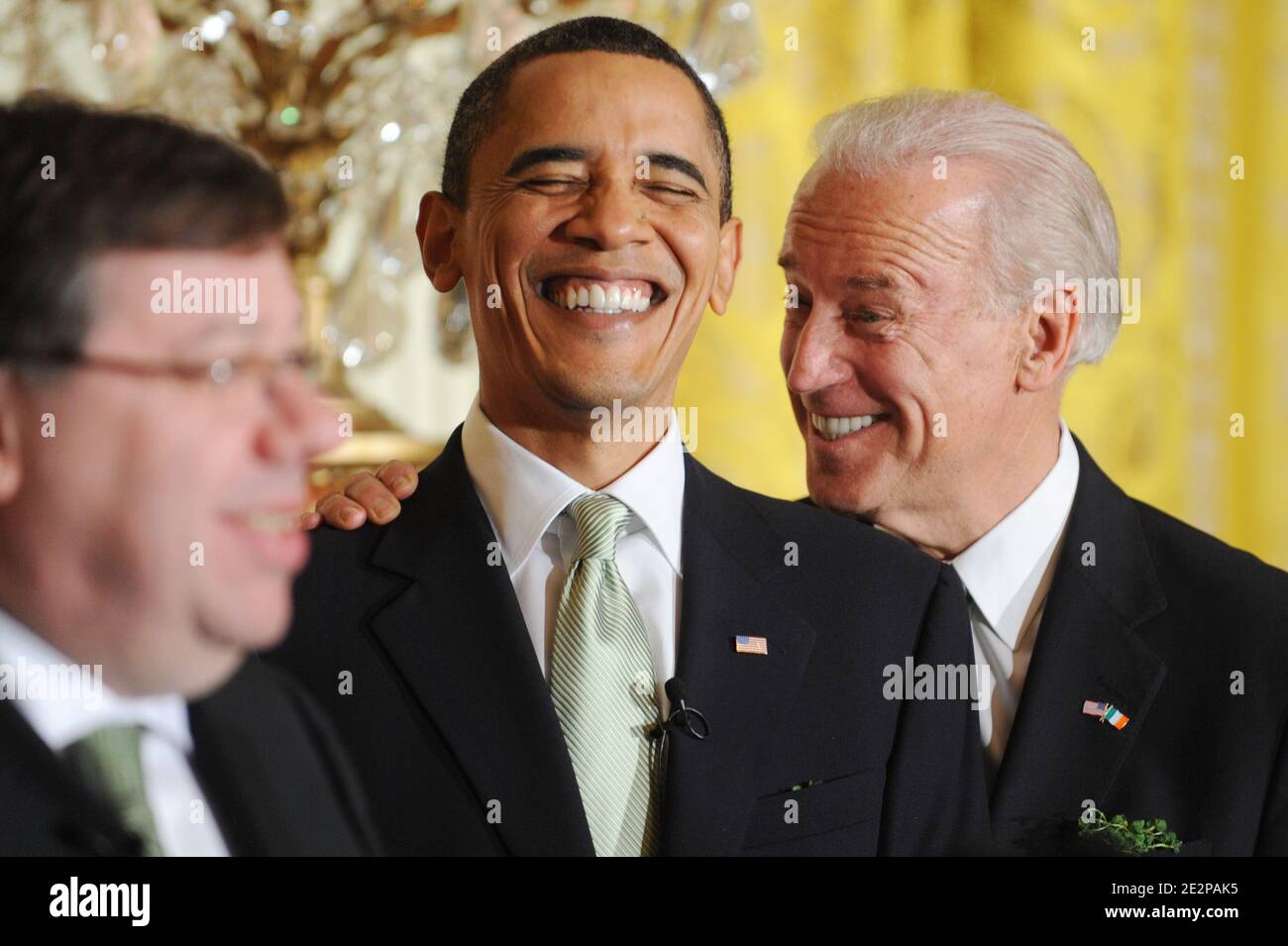 US President Barack Obama (C) and US Vice President Joe Biden (R) laugh while listening to Prime Minister (Taoiseach) of Ireland Brian Cowen (L) during the annual St. Patrick's Day Reception in the East Room of the White House, in Washington DC, USA, on March 17, 2010. President Obama and the Prime Minister (Taoiseach) of Ireland Brian Cowen delivered remarks and participated in a traditional Shamrock ceremony. Photo by Michael Reynolds/Pool/ABACAPRESS.COM Stock Photo
