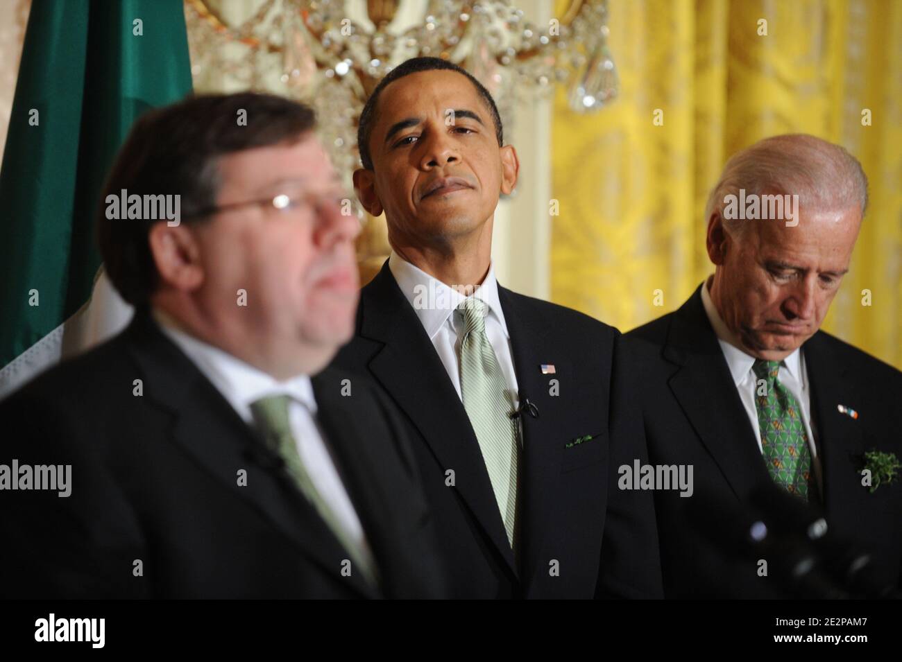 US President Barack Obama (C) and US Vice President Joe Biden (R) listen to Prime Minister (Taoiseach) of Ireland Brian Cowen (L) deliver remarks during the annual St. Patrick's Day Reception in the East Room of the White House, in Washington DC, USA, on March 17, 2010. President Obama and the Prime Minister (Taoiseach) of Ireland Brian Cowen delivered remarks and participated in a traditional Shamrock ceremony. Photo by Michael Reynolds/Pool/ABACAPRESS.COM Stock Photo