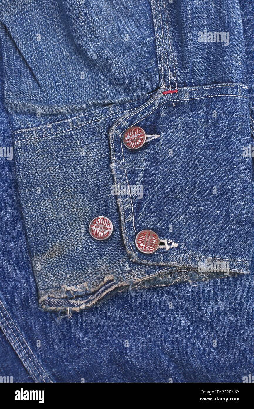 Denim shirt cuff with copper rivet closeup Stock Photo - Alamy