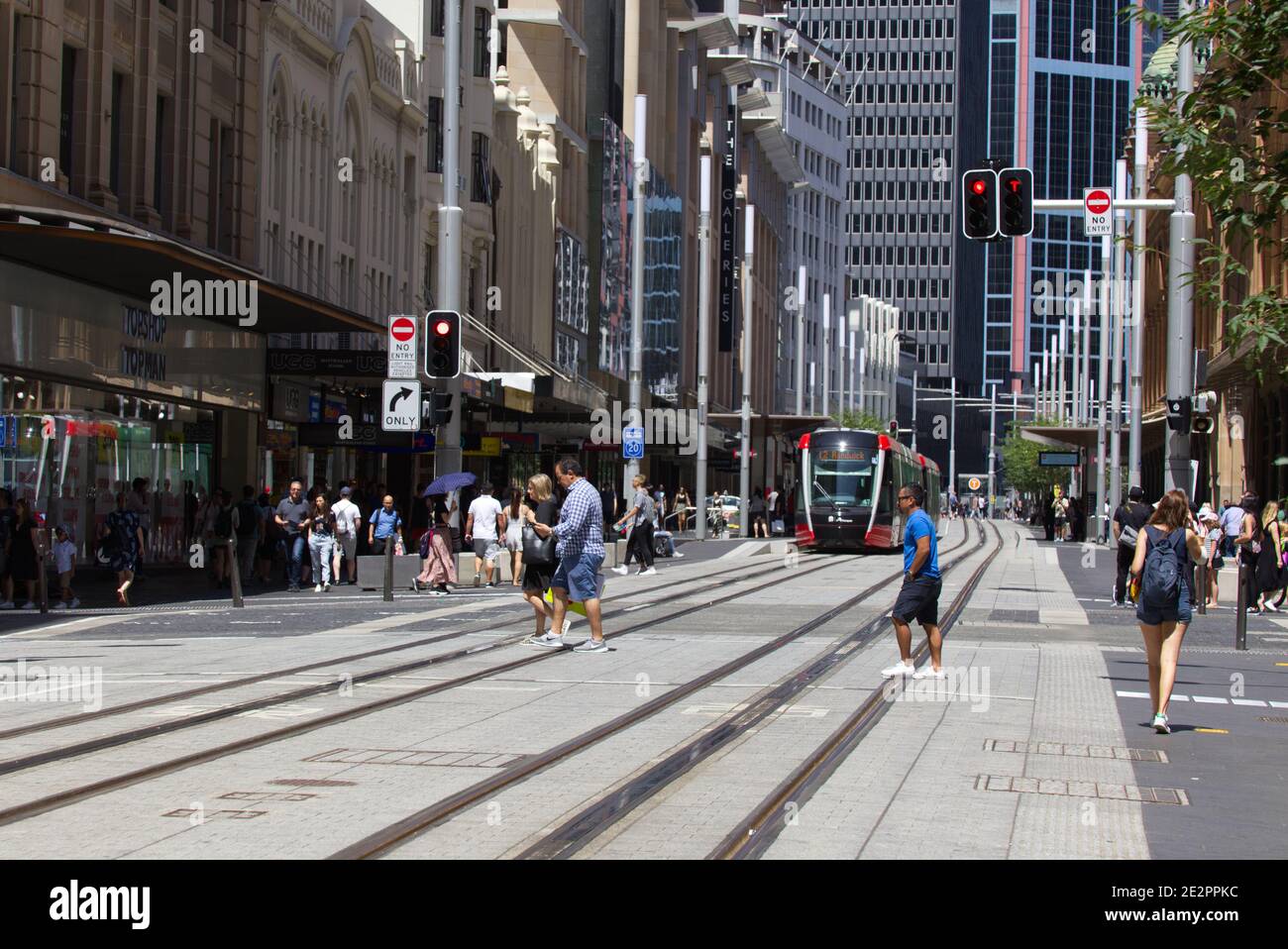 Pedestrians crossing over Light Rail system on George Street Sydney Australia Stock Photo