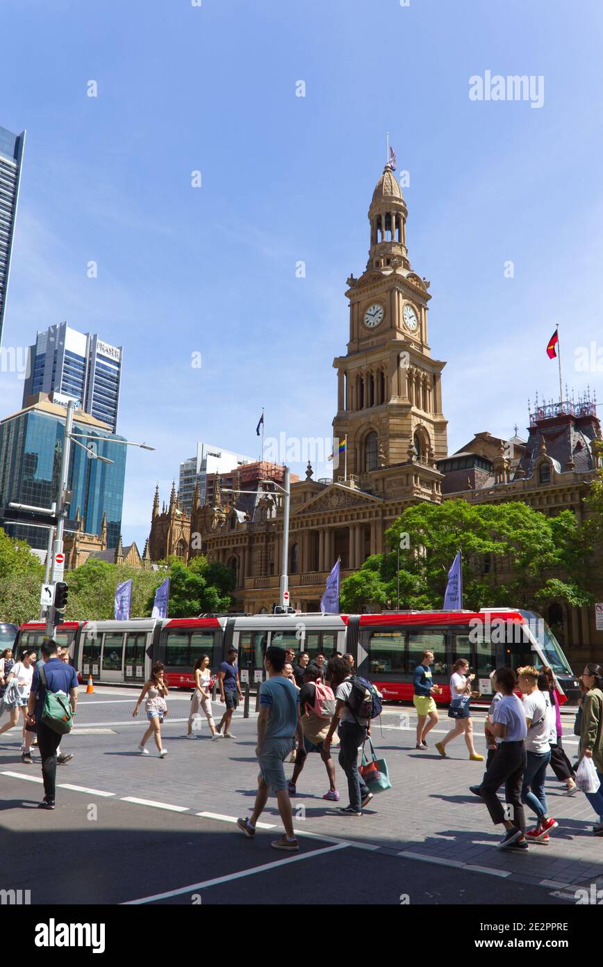 Pedestrians crossing George street in front of the Sydney Town Hall Australia Stock Photo