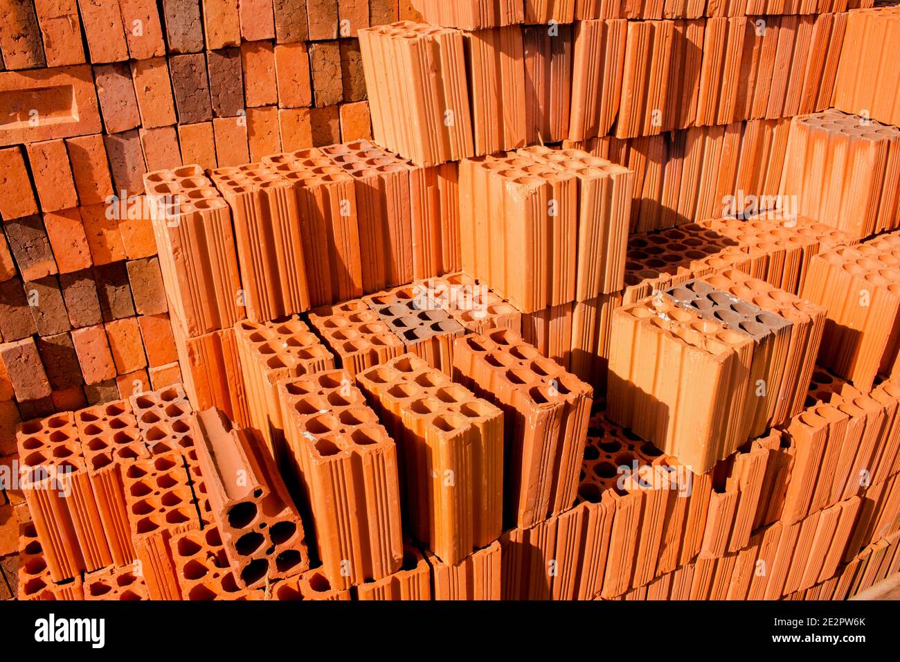 Stacks of red and brown clay bricks and blocks for general construction and reform Stock Photo