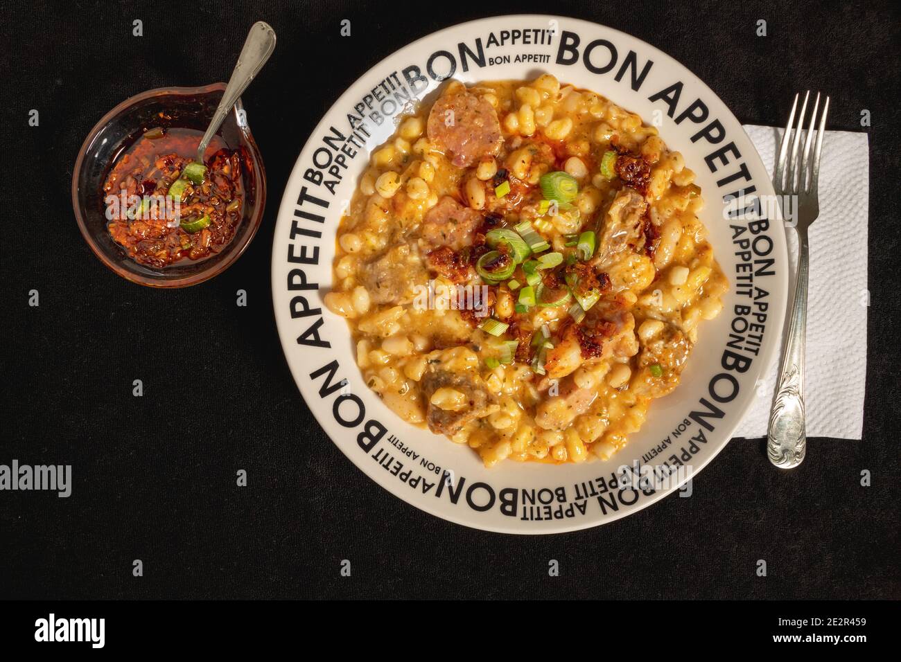 White plate with the text bon appetit with Locro served, traditional