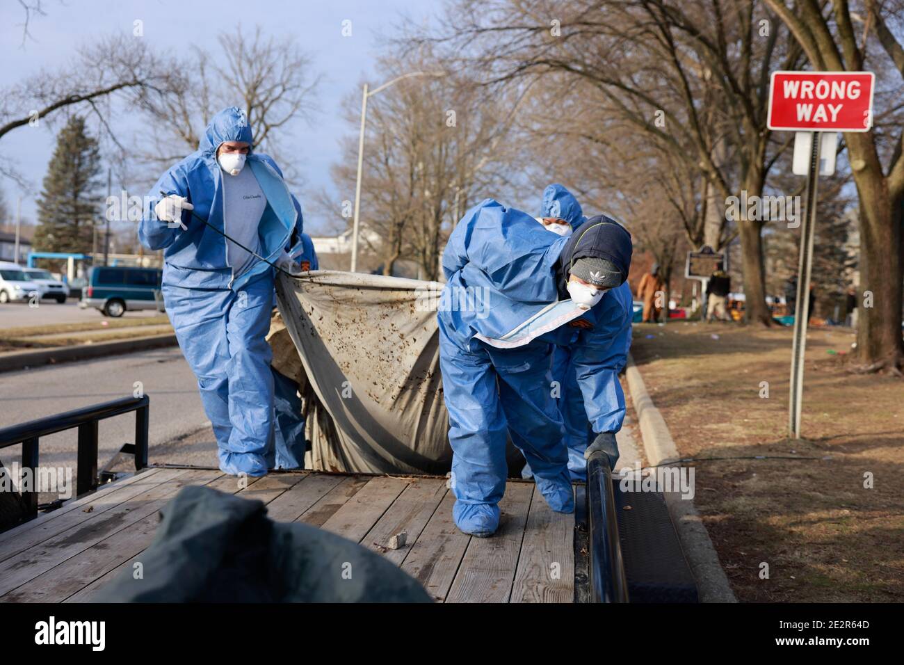 A work crew dressed in PPE (Personal protective equipment) removes items belonging to community members experiencing homelessness from along S. College Avenue. The City of Bloomington evicts members of the community who are experiencing homelessness from the right-of-way along S. College, which was not subject to Parks and Recreation rules that tents could be pitched until 11 p.m. Workers from Centerstone arrived around 1:30 p.m., then police, and workers from the city who were dressed in PPE arrived later. Stock Photo