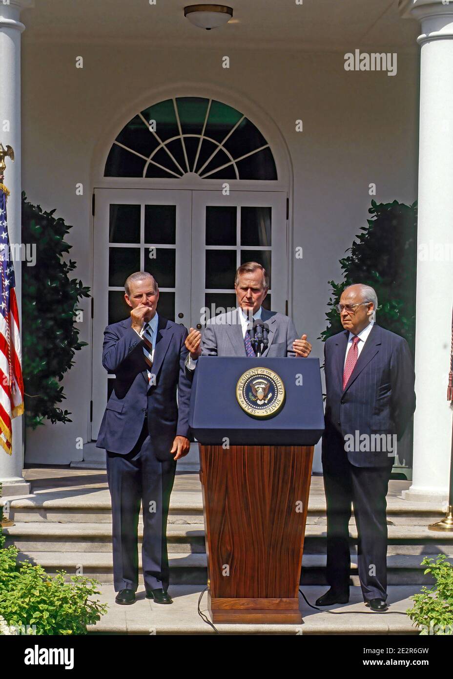 Washington, DC.USA, August 20.1991  President George H.W. Bush, flanked by Secretary of State James Baker III, left, and U. S. Ambassador to the Soviet Union Robert Strauss, holds his ninety-eighth news conference in the Rose Garden during the morning. President Bush opened the conference with an address on the attempted coup in Soviet Union and answers questions mainly geared toward foreign policy Stock Photo