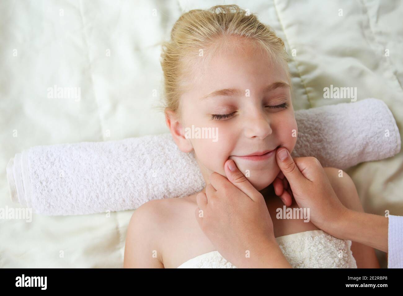 Masseur doing face massage to child Stock Photo Alamy