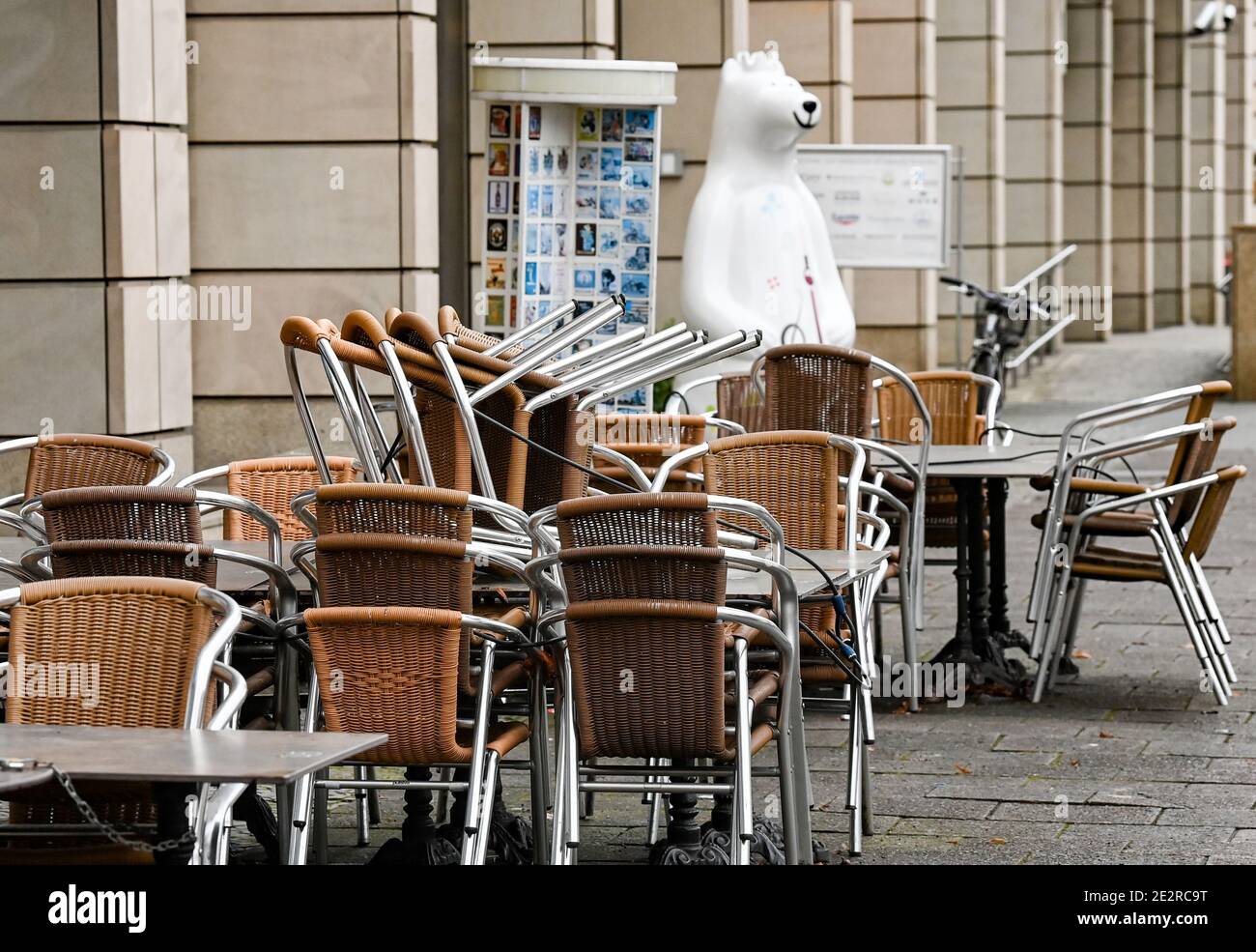 Berlin, Germany. 14th Jan, 2021. Stacked chairs and blocked tables from Cafe Lebensart stand on Unter dem Linden. A Berlin bear can be seen in the background. Due to the lockdown, shops, cafes and restaurants are closed. Credit: Jens Kalaene/dpa-Zentralbild/ZB/dpa/Alamy Live News Stock Photo
