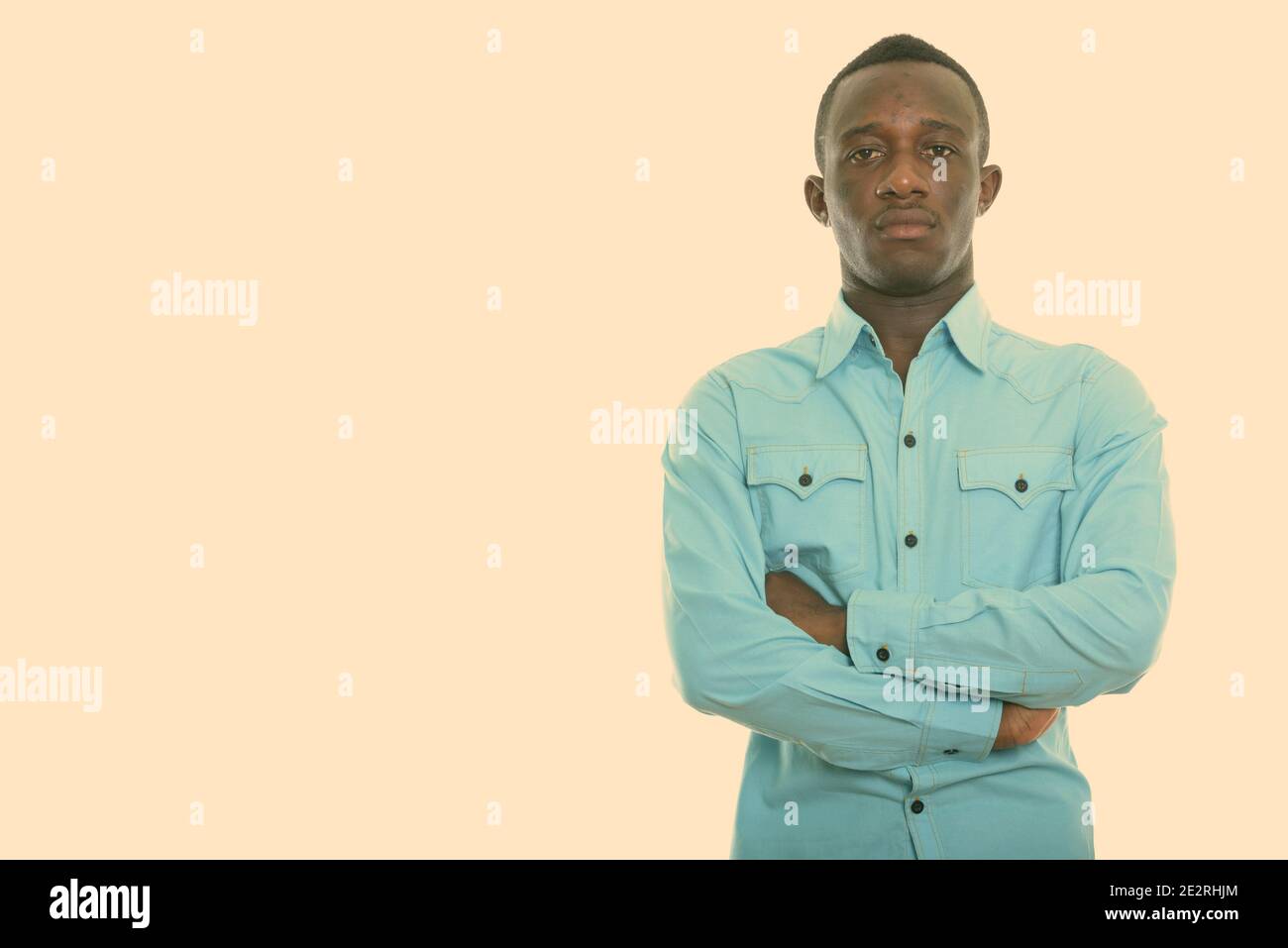 Studio shot of young black African man with arms crossed Stock Photo ...