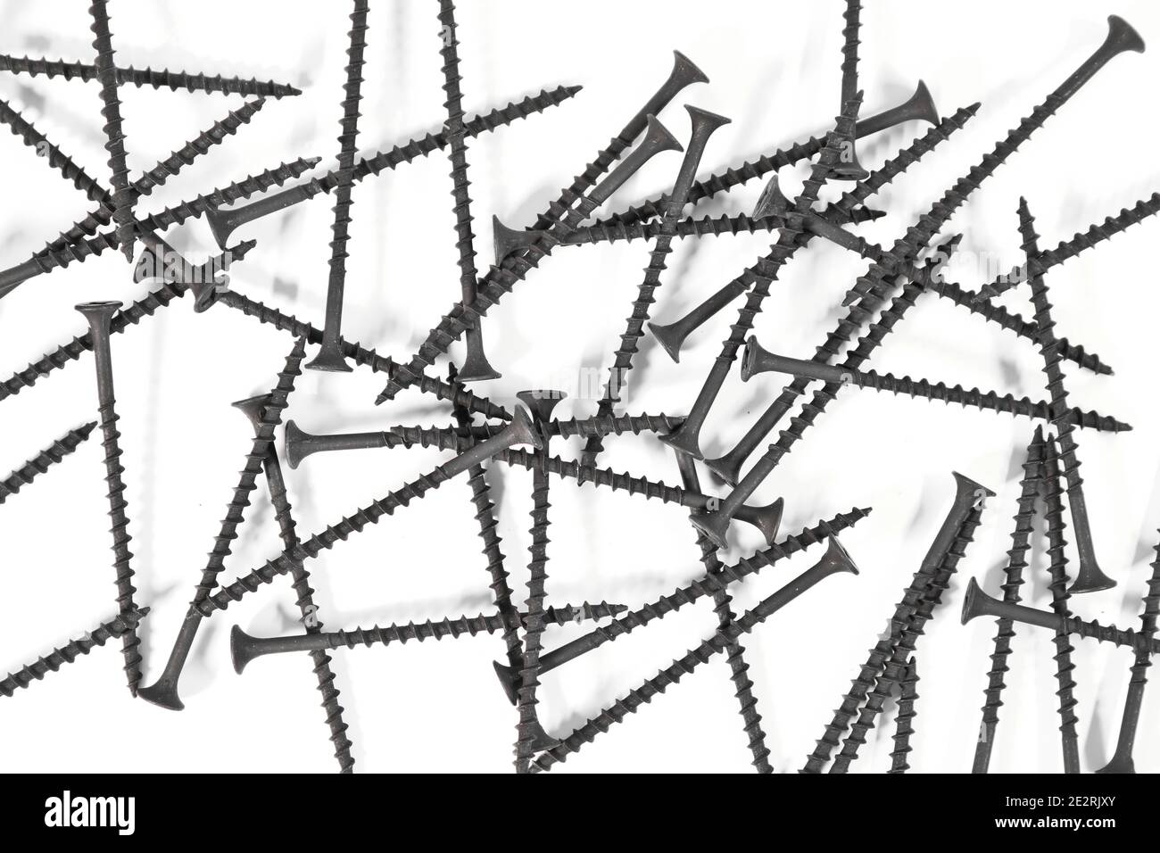 A bunch of selftapping screws for wood surfaces on a white background