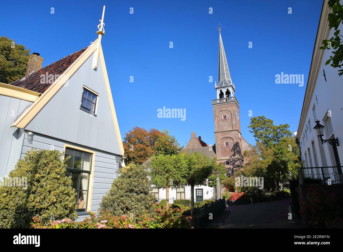 Broek in Waterland, a small town with traditional old and painted wooden houses, North Holland, Netherlands, with the bell tower of the church Stock Photo