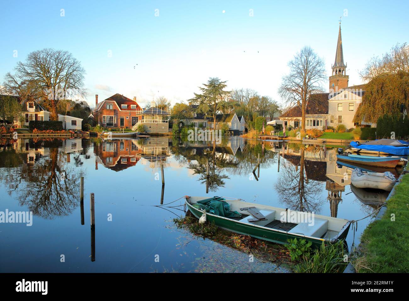 Broek in Waterland, a small town with traditional old and painted wooden houses, North Holland, Netherlands, with reflections of the houses Stock Photo