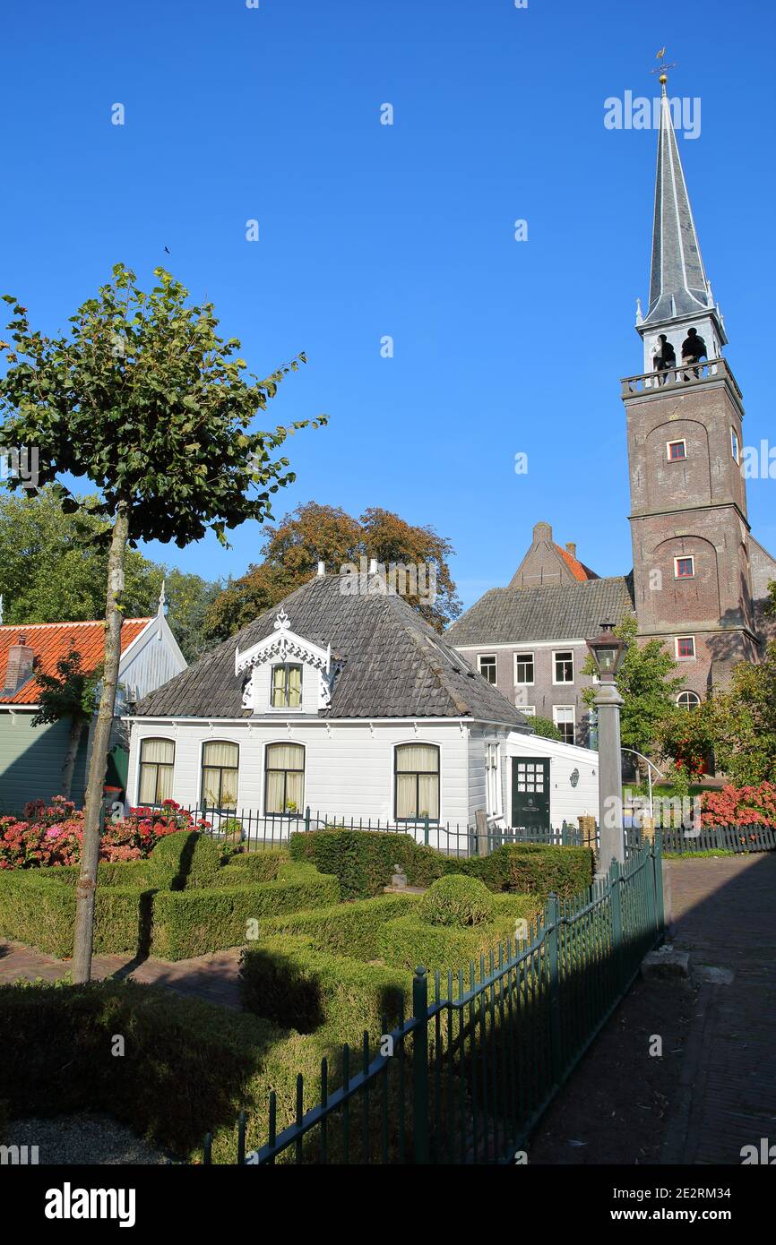 Broek in Waterland, a small town with traditional old and painted wooden houses, North Holland, Netherlands, with the bell tower of the church Stock Photo