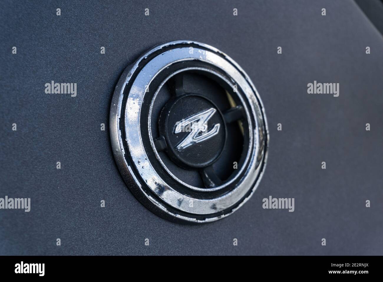 Close up detail of the Z emblem badge on a matte black customised Datsun Fairlady 280Z GT coupe 1970s sports car Stock Photo