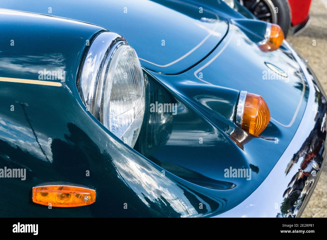 Close up detail of the headlights and bonnet of a 1972 British racing green Lotus Europa Special classic sports car Stock Photo