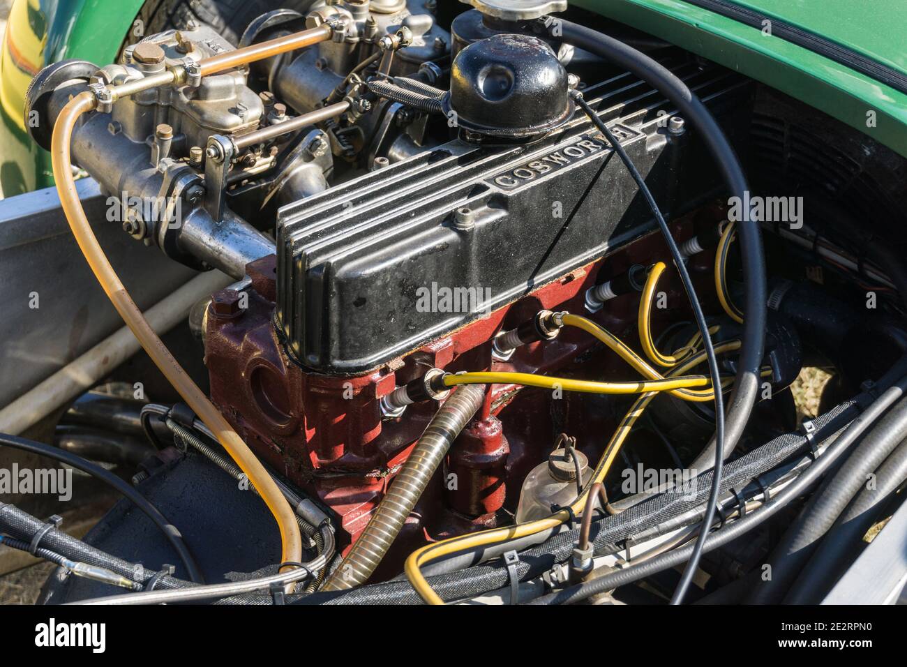 Close up detail of the Cosworth engine in a British racing green 1960s Lotus Seven lightweight open top sports car Stock Photo