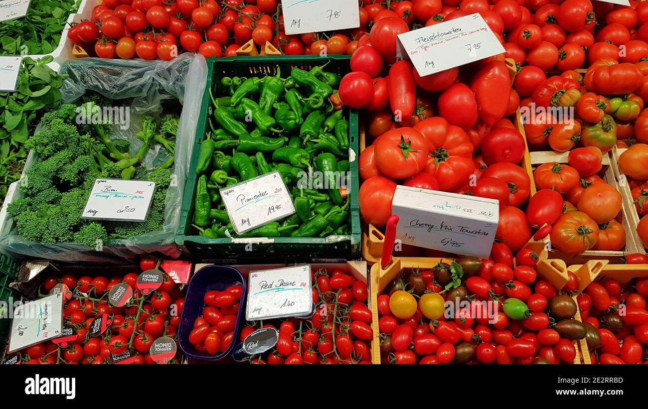 Colorful green and red vegetables and groceries at a market Stock Photo ...