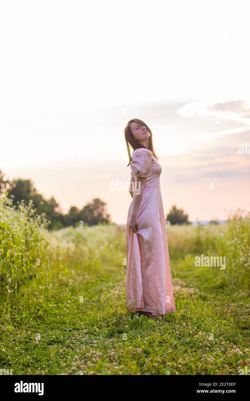 Woman standing in a field of flowers hi-res stock photography and ...