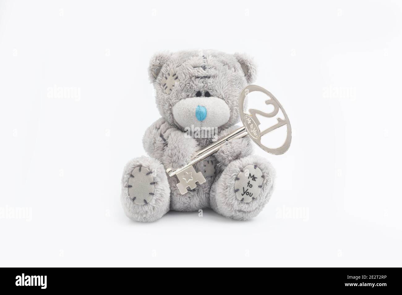 A 21st Birthday Teddy Bear with a key to the door. Stock Photo