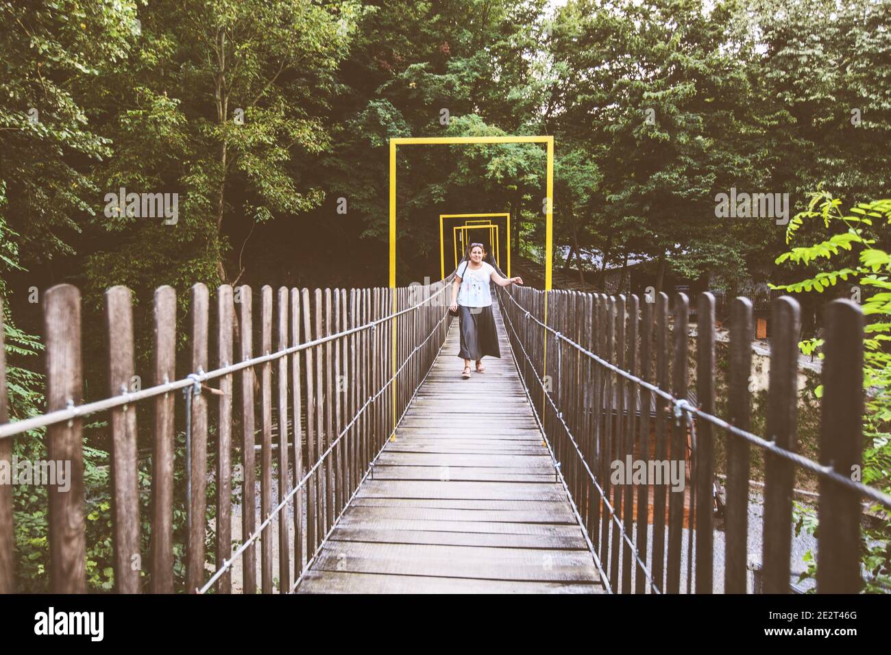 Woman crossing rope bridge hi-res stock photography and images - Alamy