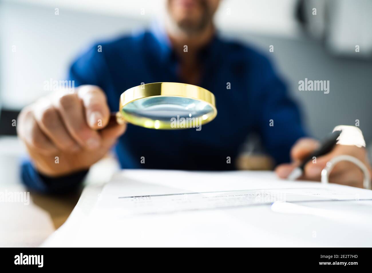 Fraud Detective Using Magnifying Glass Or Loupe Stock Photo