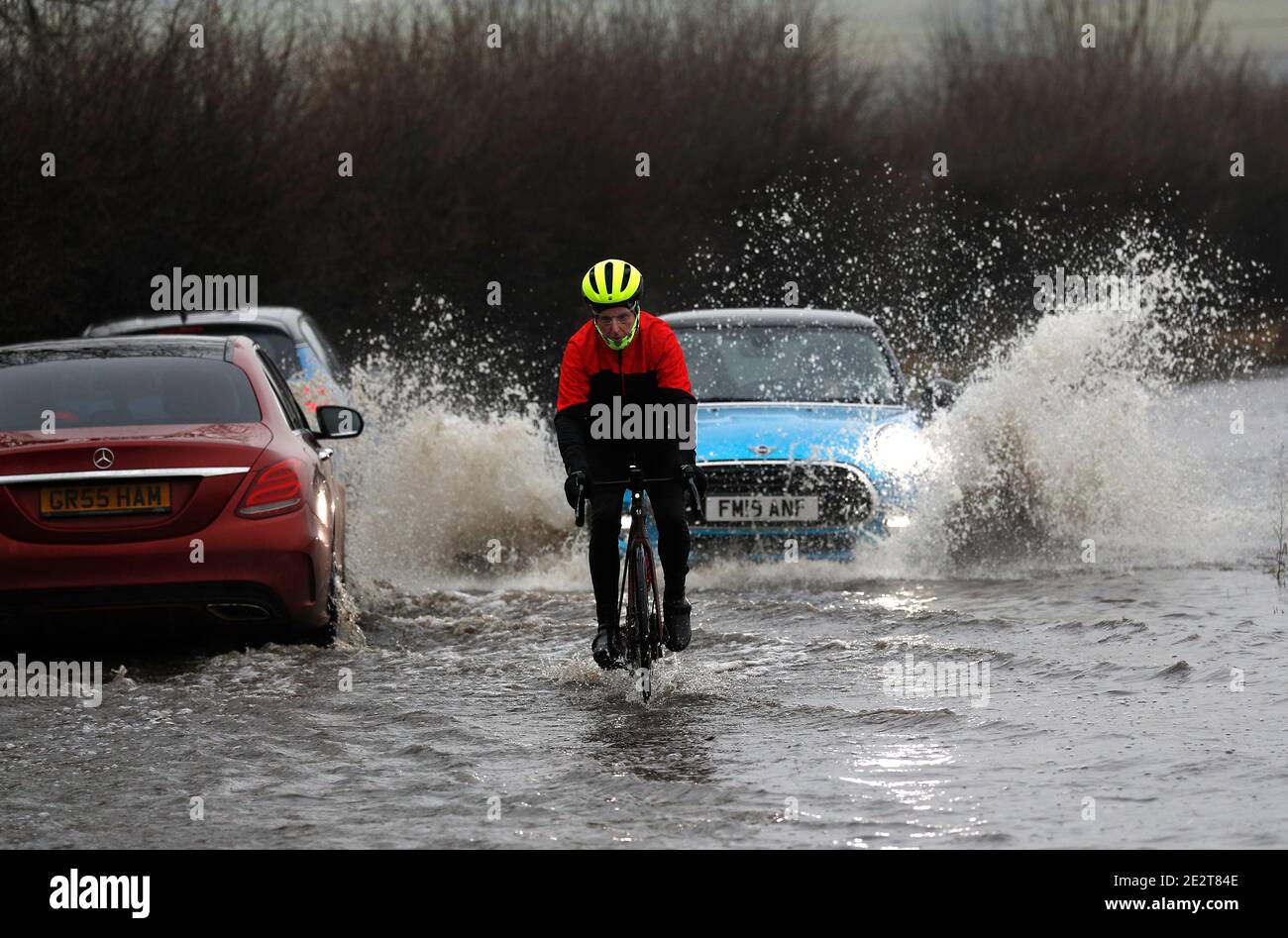 Leicester, Leicestershire, UK. 15th January 2021. UK weather.  A man rides through flooding in Loughborough after the Met Office warned of below freezing temperatures across many parts of England after heaving rain and snow. Credit Darren Staples/Alamy Live News. Stock Photo