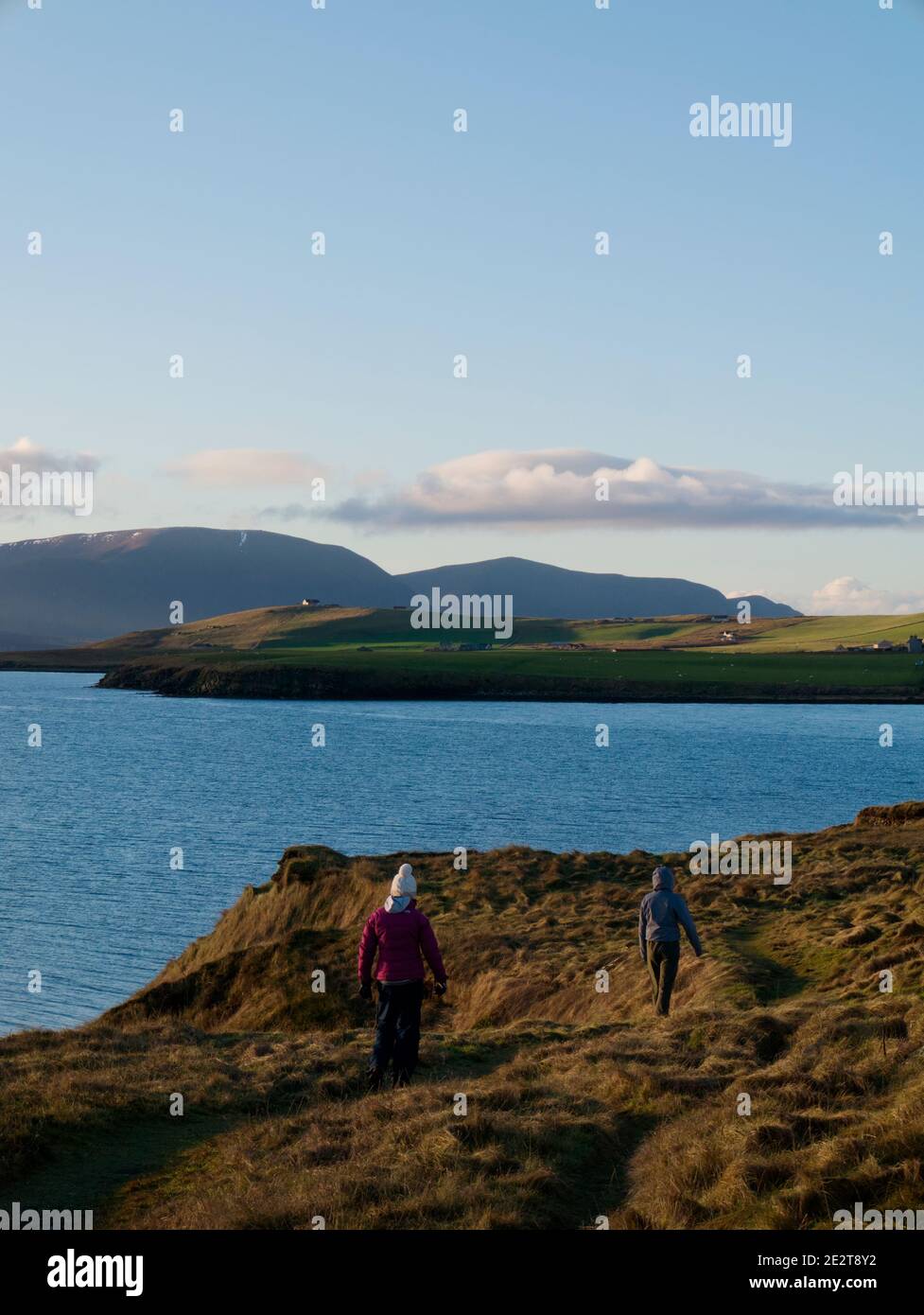 Family walking on coastal path, Orkney Isles Stock Photo