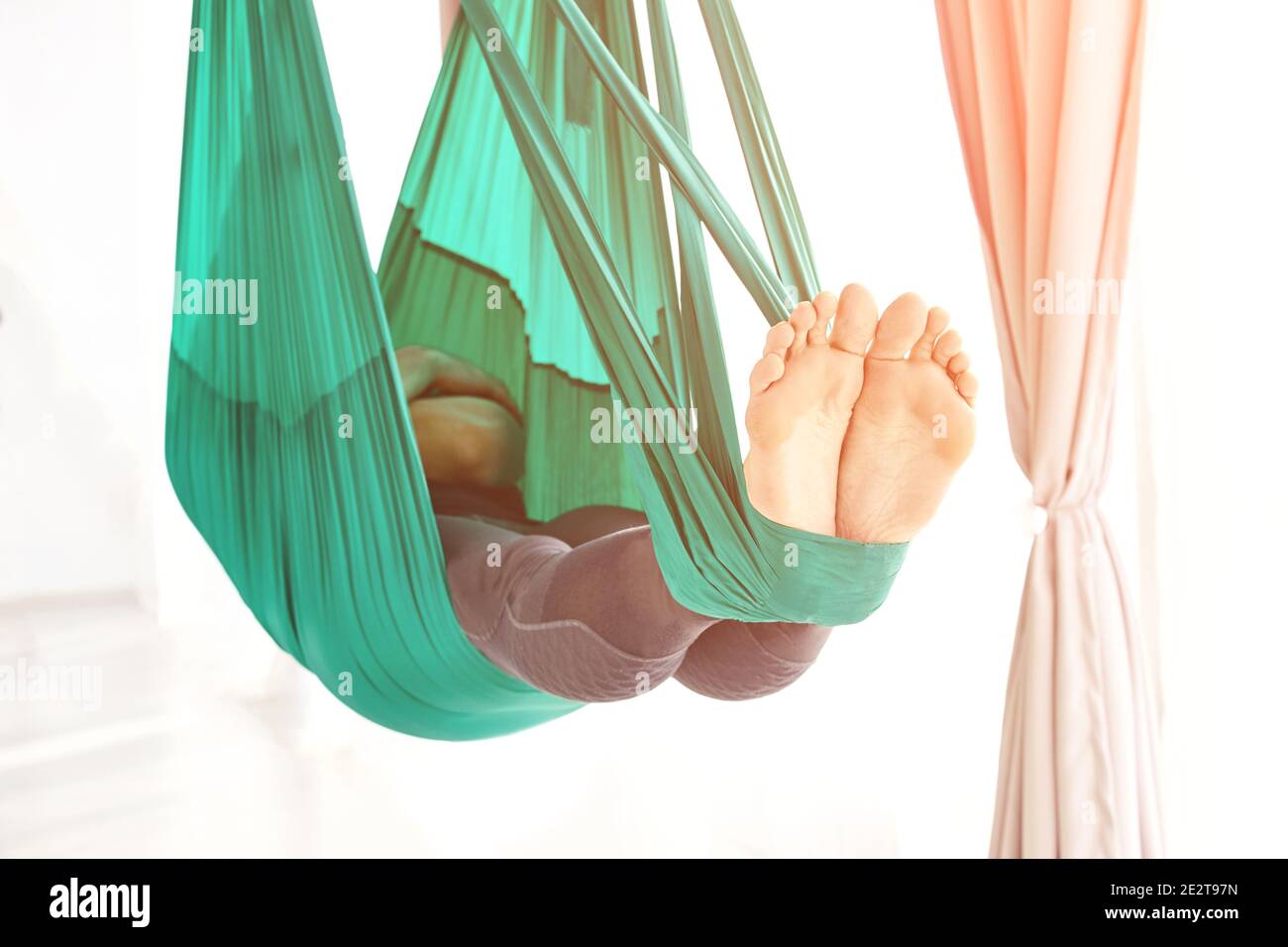 Male person do hammock yoga class exercise. Meditation in air calm