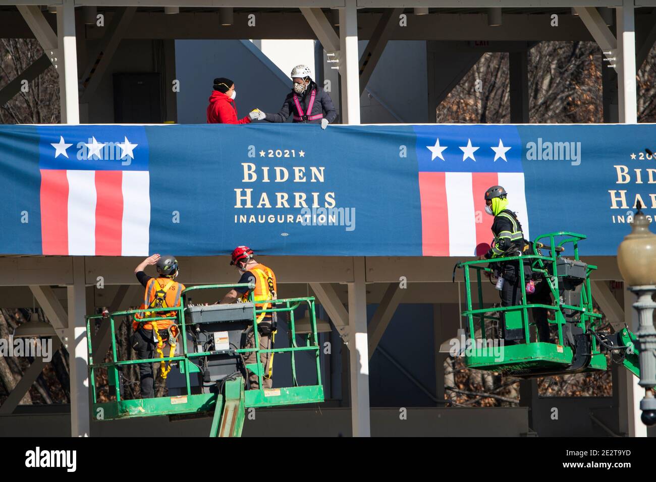 Workers hang bunting from a media riser for President-elect Joe Biden's inauguration parade outside the White House in Washington, DC, USA, 14 January 2021.Credit: Jim LoScalzo/Pool via CNP /MediaPunch Stock Photo