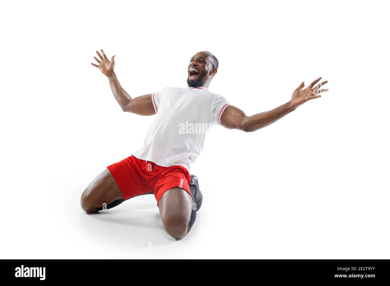 Crazy, mad happiness. Funny emotions of professional football, soccer player isolated on white studio background. Excitement in game, human emotions, facial expression and passion with sport concept. Stock Photo