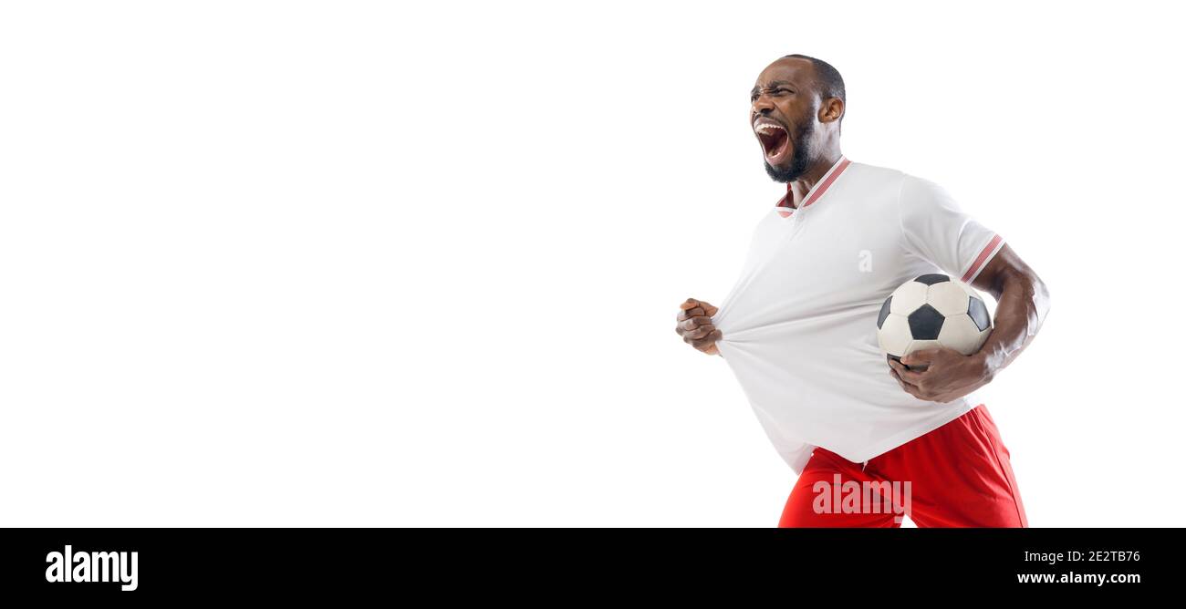 Mad screaming. Funny emotions of professional football, soccer player isolated on white studio background. Excitement in game, human emotions, facial expression and passion with sport concept. Flyer Stock Photo