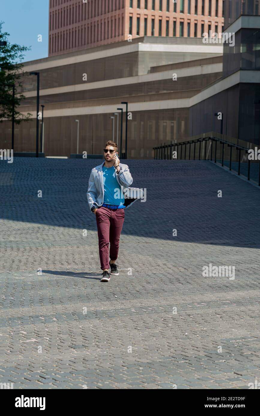 Young trendy modern man walking hi-res stock photography and images - Alamy