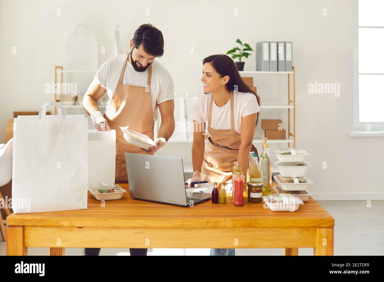 Food delivery service workers packing online orders for takeout healthy