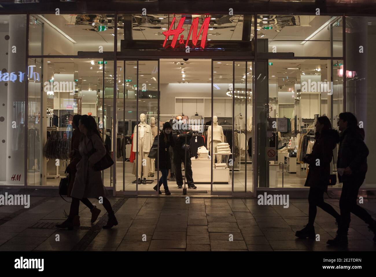 BELGRADE SERBIA DECEMBER 21 2020 Security guard Staff worker employee observing clients going out of a H M fashion retailer clothing shop wearin Stock Photo Alamy