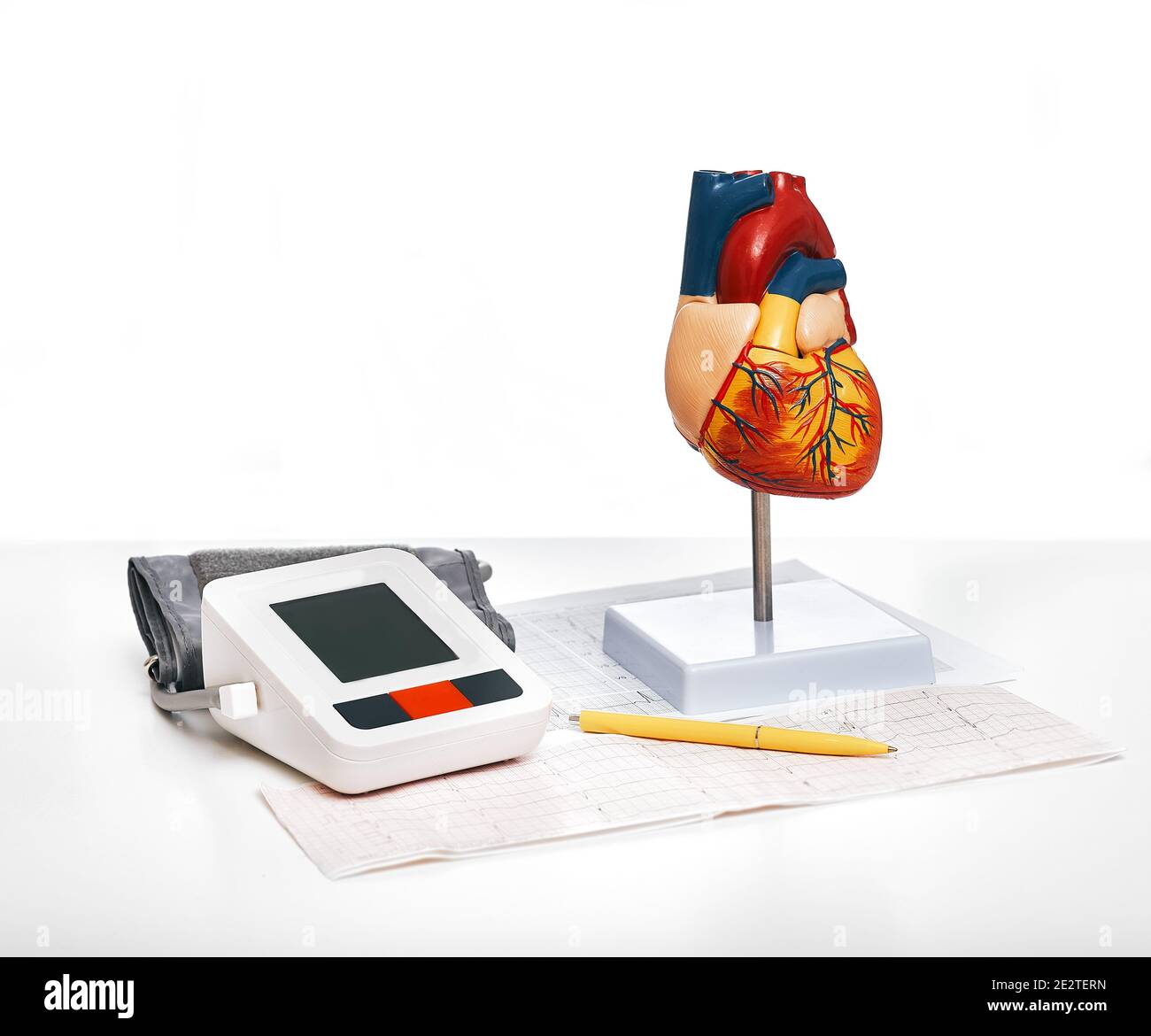 Checking blood pressure and heart health. Anatomical model of the human heart and blood pressure tonometer, close up. Preventive diagnosis of cardiac Stock Photo