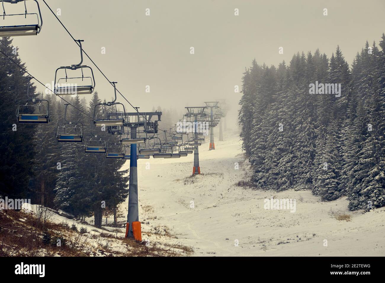 Empty ski lift waiting for snow Stock Photo