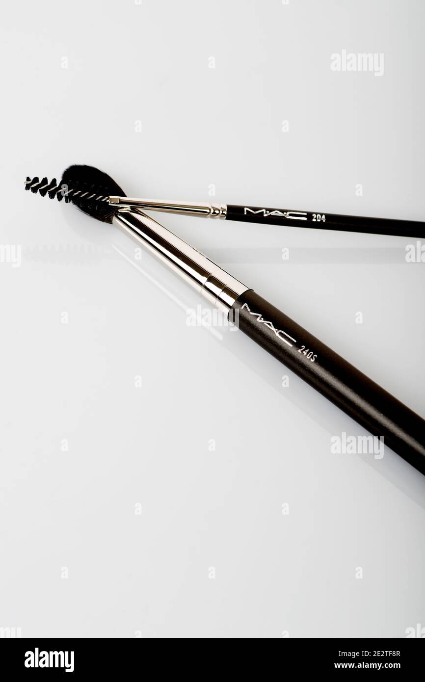 M.A.C beauty products. P for Potent MAC POWDER KISS LIPSTICK and 240 SYNTHETIC LARGE TAPERED BLENDING BRUSH, 204 SYNTHETIC LASH BRUSH Stock Photo