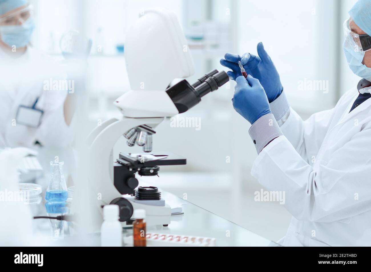 scientist opening an ampoule with a new vaccine Stock Photo Alamy