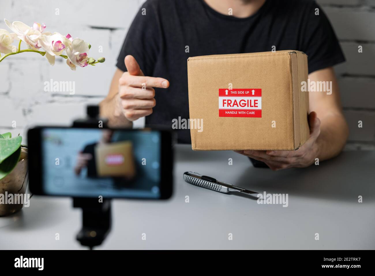 social media influencer recording product unboxing video. online marketing Stock Photo