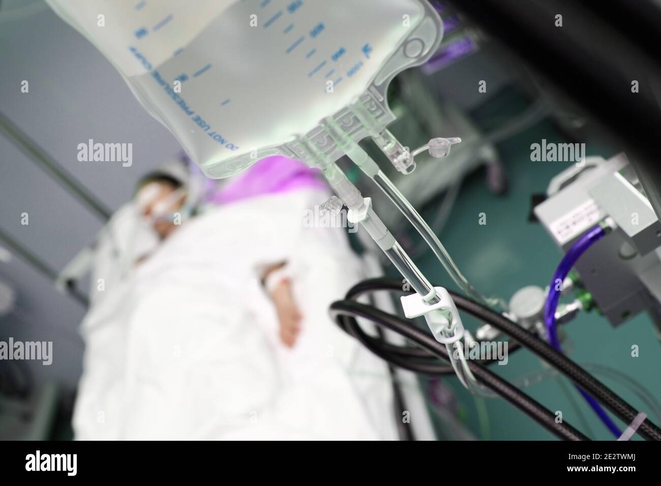 Comatose patient under iv drip in ER. Stock Photo