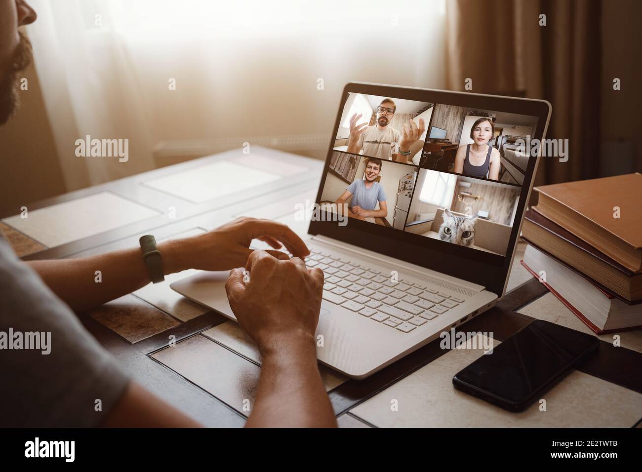 Back view of man talking to his colleagues about plan in video ...