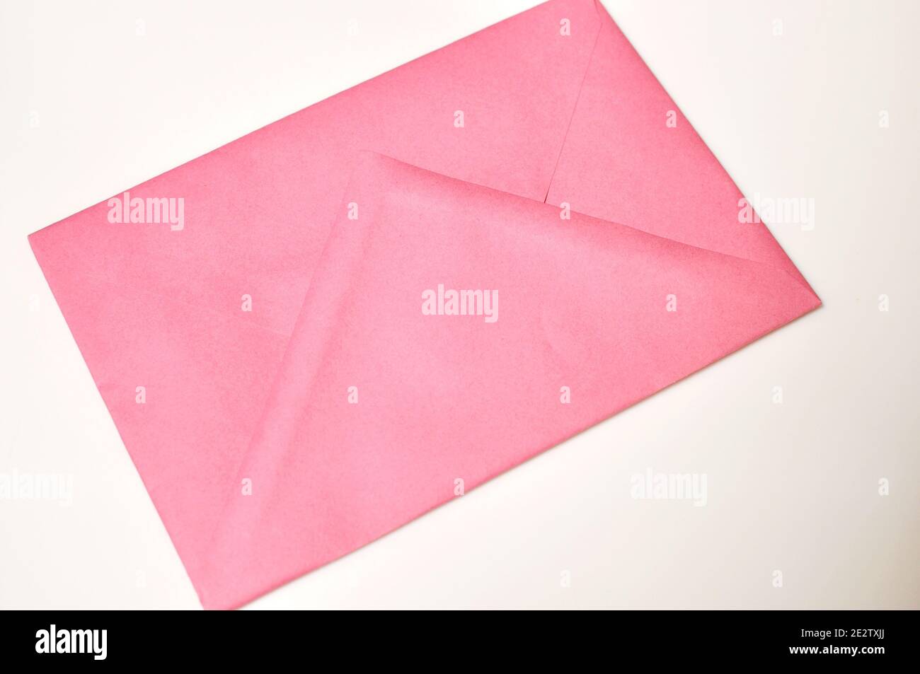 Red closed blank envelope on beige background Stock Photo