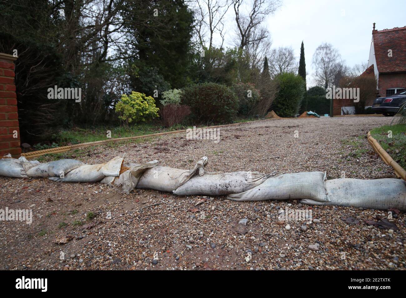 Sandbags are laid across a driveway after a nearby road flooded when the River Chelmer burst its banks in the village of Great Easton, Dunmow. Flood warnings were issued to large parts of England on Friday following heavy rainfall. Stock Photo