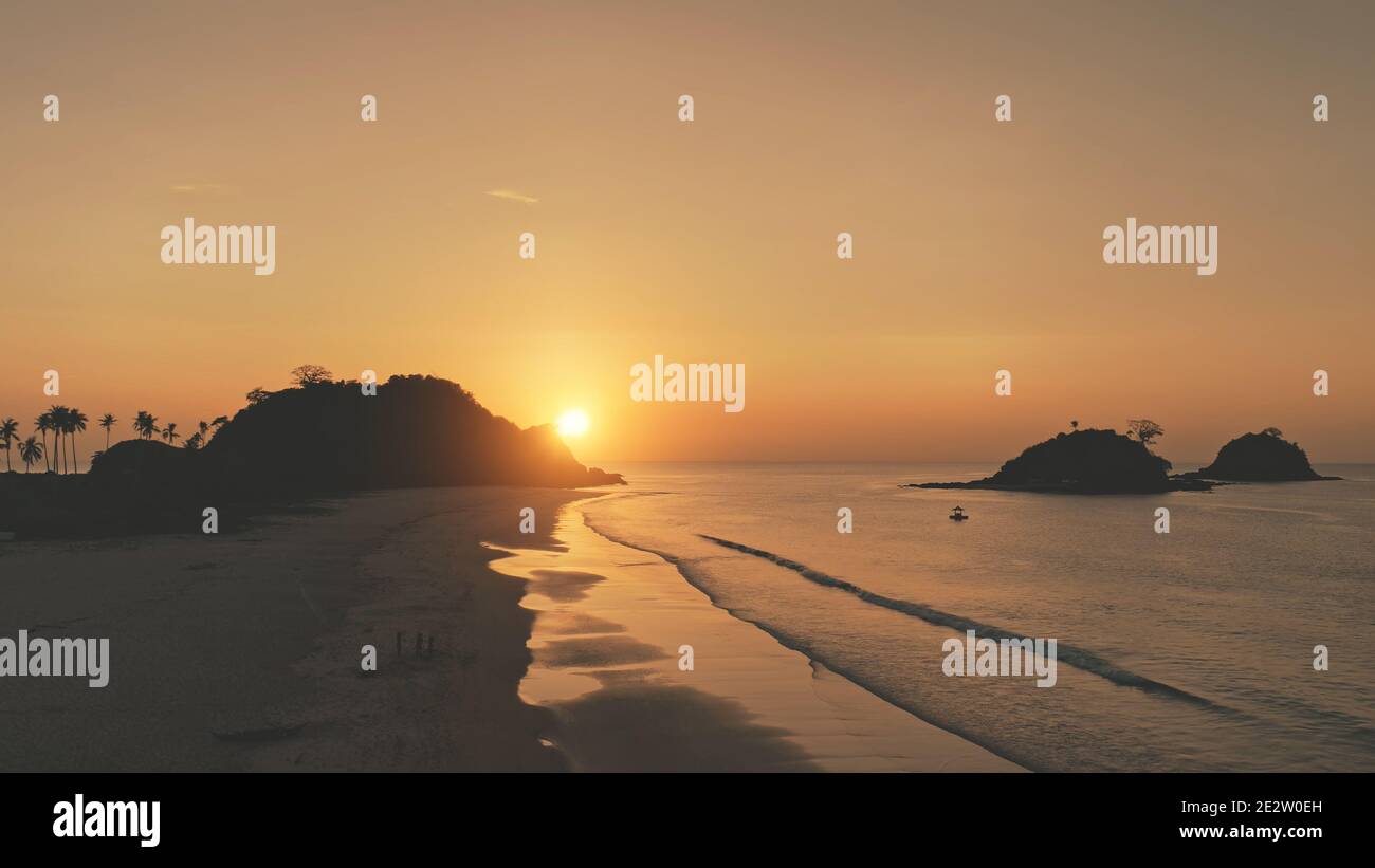Sunset over mountains islands. silhouette Nobody nature seascape of ocean bay. Tropic landscape of sand beach. Summer scenery of Philippines, Asia. Cinematic soft drone shot Stock Photo