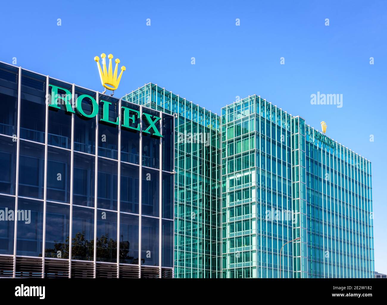 The Rolex logo at the top of a building at the headquarters of the swiss brand of luxury watches in Geneva. Stock Photo