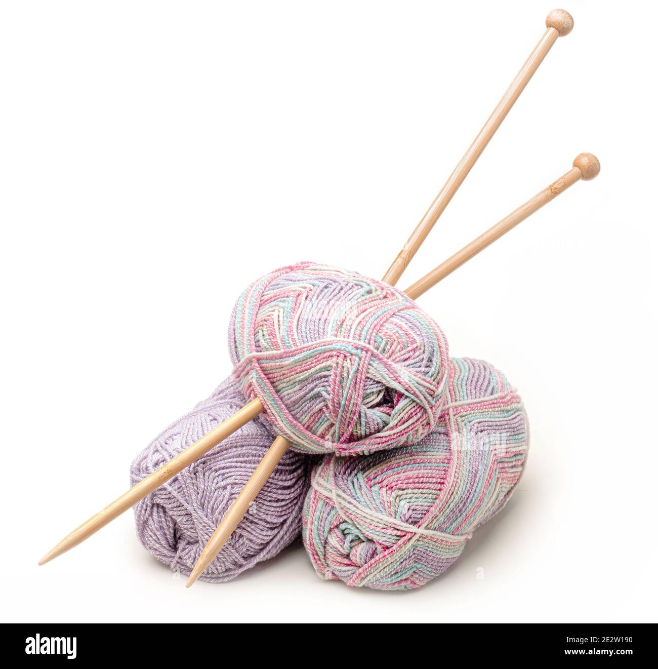 Knitting balls of wool with needles isolated against white Stock
