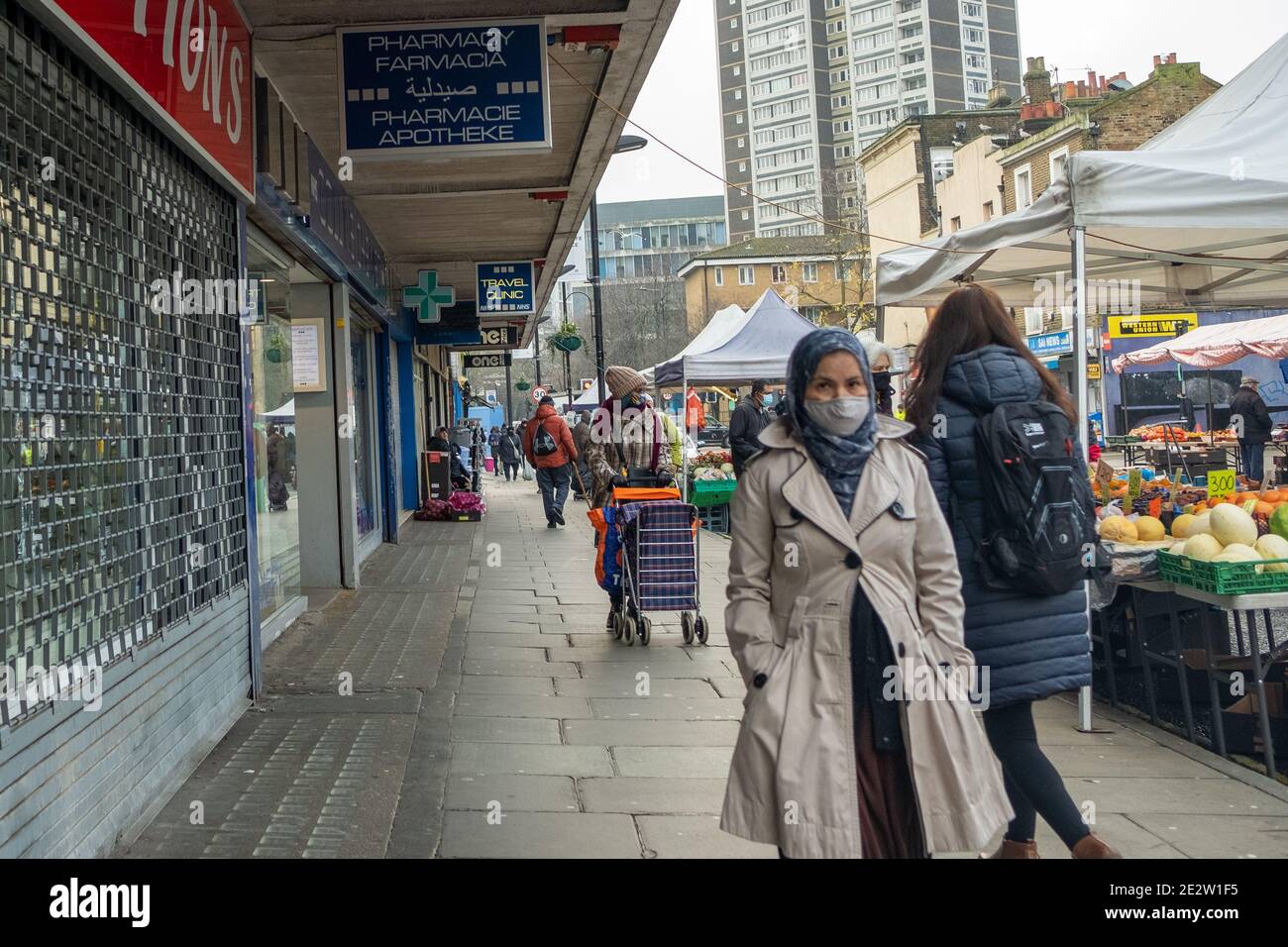 London- January 2020: Ethnically diverse people wearing Covid 19 face masks on Church Street off Egdware Road in Westminster. Stock Photo